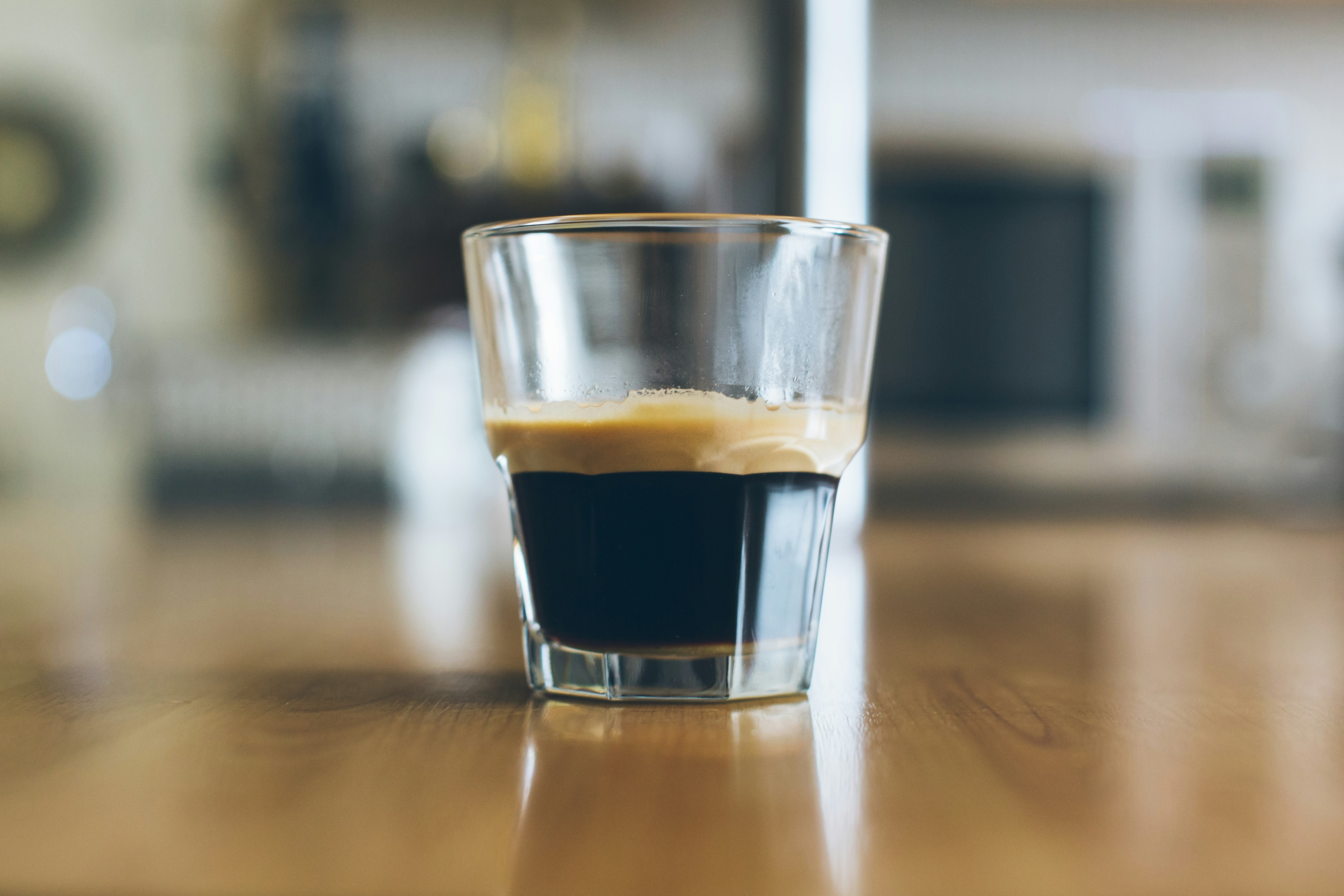 clear shot glass on wooden table